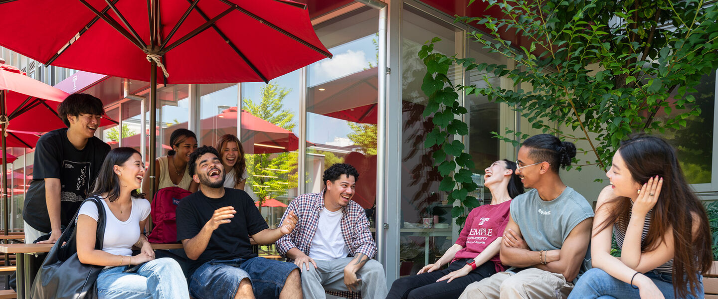 Students chatting in the TUJ campus courtyard