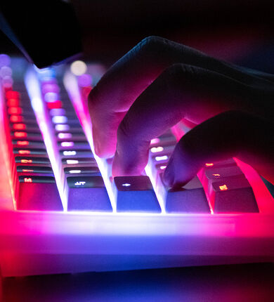 Hands typing on a keyboard.