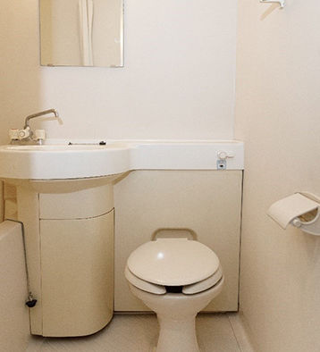 An image of a standard single room equipped with a private bathroom.
