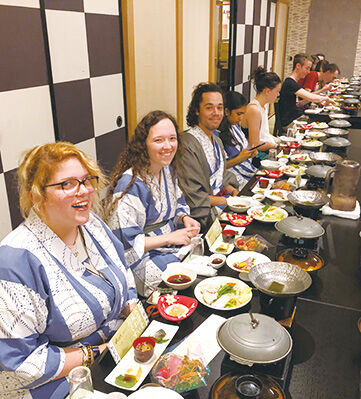 TUJ students enjoying dinner in yukata while traveling.