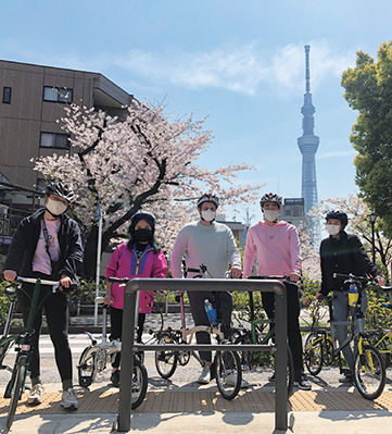 TUJ students enjoy cycling while looking at the Tokyo Sky Tree and cherry blossoms.