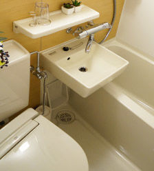 An image of a standard single room equipped with a private bathroom with shower.