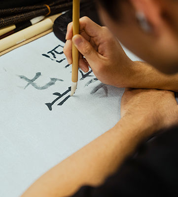 A TUJ student is writing kanji in 