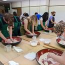 A picture of students making soba noodles.