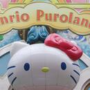 A picture of Hello Kitty in front of Sanrio Puroland