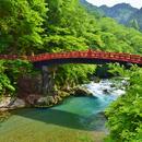 A picture of a red bridge over a river in Nikko