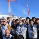 A picture of student in front of the TEPCO Power Plant