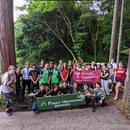  A photo of smiling students gathered in front of a sign.