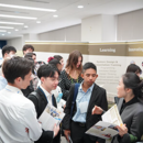 Students attending a career fair to hear from a woman