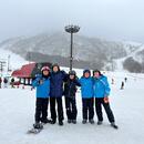 People linking arms at the ski resort