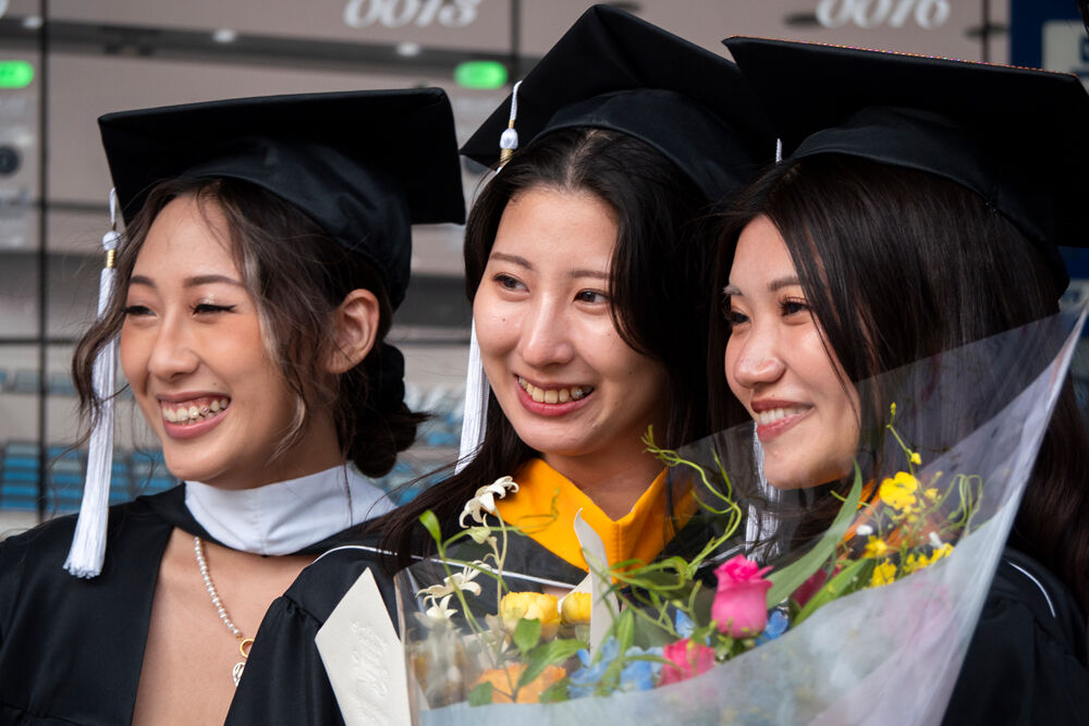 Graduates in front of Hitomi Hall
