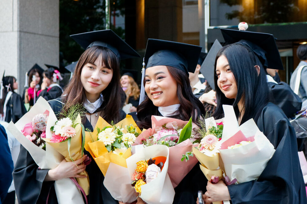 Graduates in front of Hitomi Hall