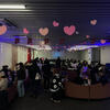 Pink paper hearts hang from the ceiling of the Parliament as students enjoy a frightful and delightful romance movie. 