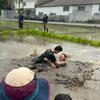 Students having a mud fight in the rice field