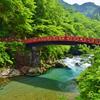 A picture of a red bridge over a river in Nikko