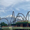 A picture of Fuji-Q highland rollercoasters with Mt. Fuji in the background. 