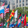 International flags displayed in front of high-rise buildings