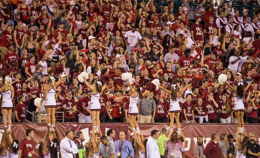 Audience watching a Temple University team match.