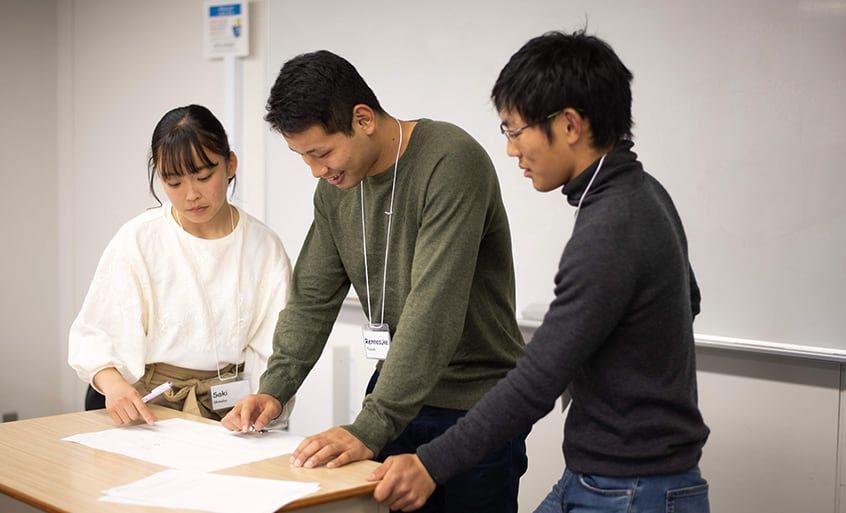 3 students giving a presentation.