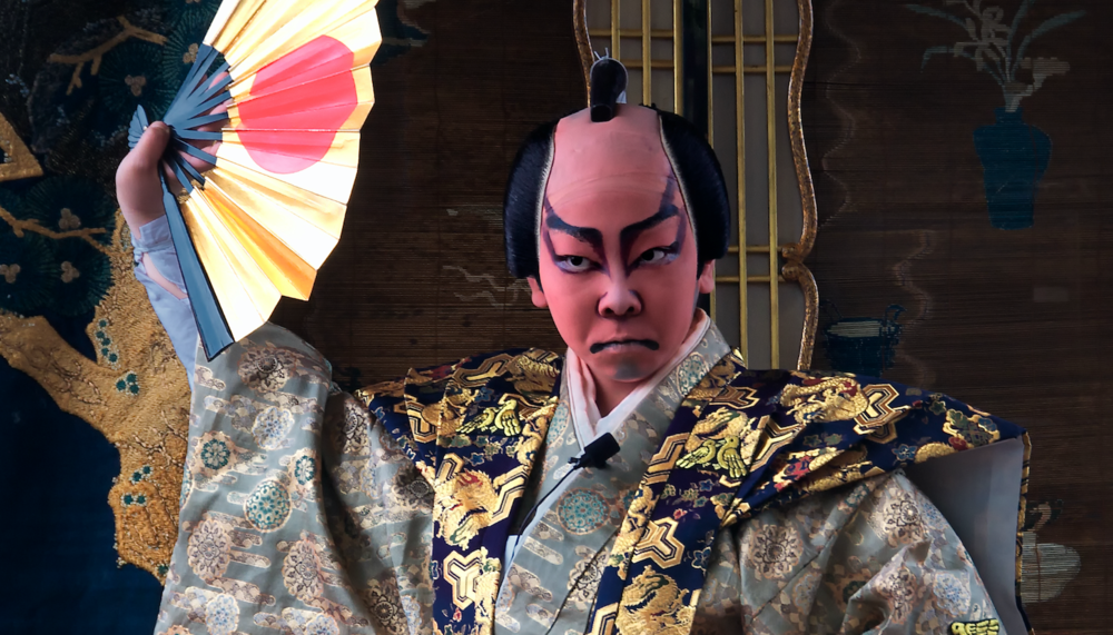 In the picture, you can see a boy dressed in traditional Kabuki clothes