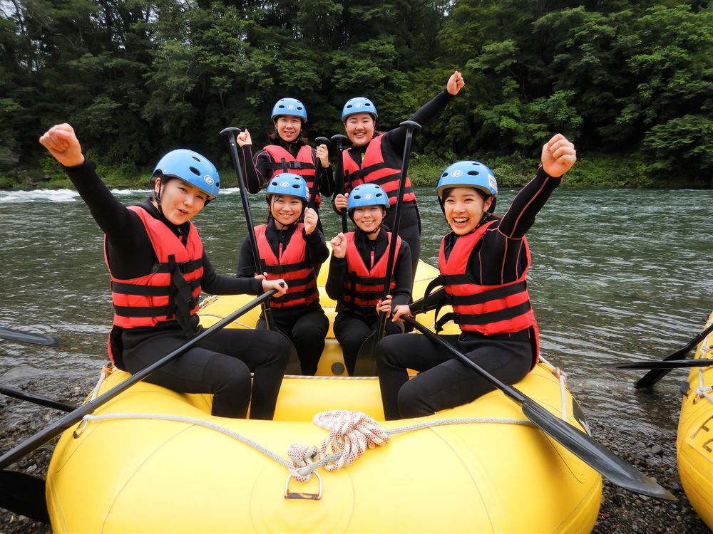 In the picture, some TUJ students are on a river raft ready to do their best!