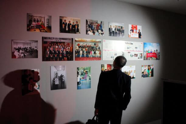At the reception — a guest looking at TUJ history through pictures