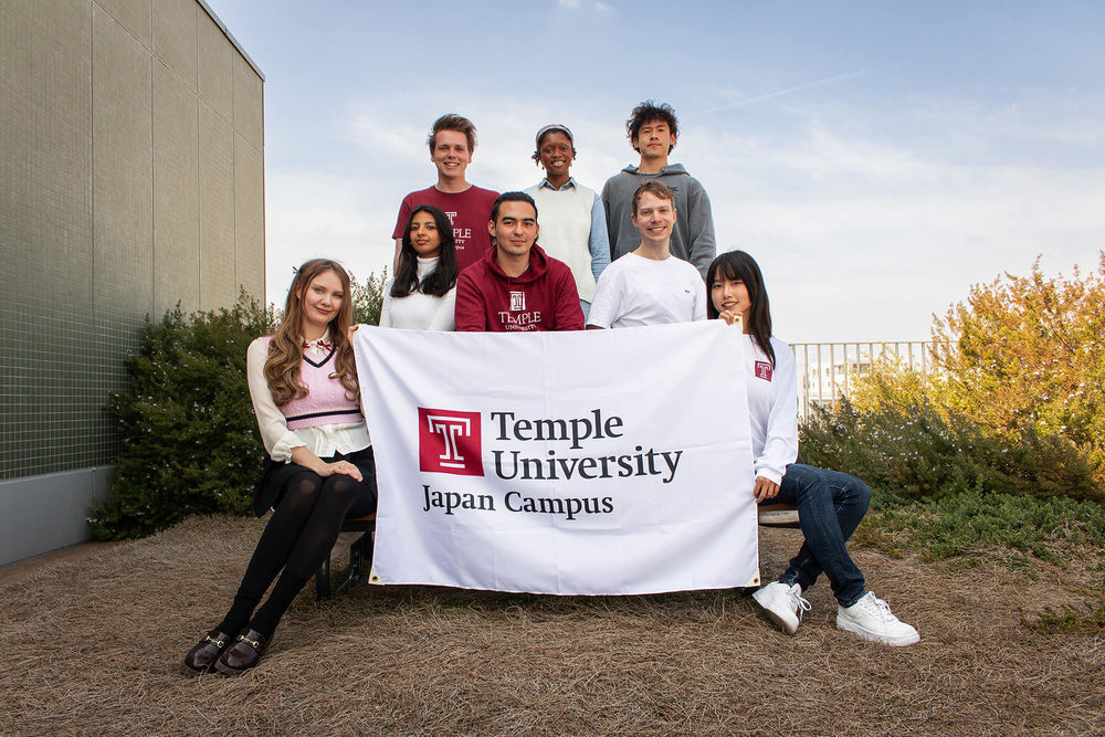 Students' group photo, holding TUJ banner