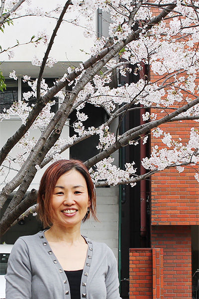 May Watabe, standing under the cherry tree.