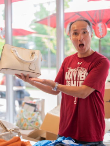 A staff member helping run the clothing giveaway during our TUJ Summer Matsuri