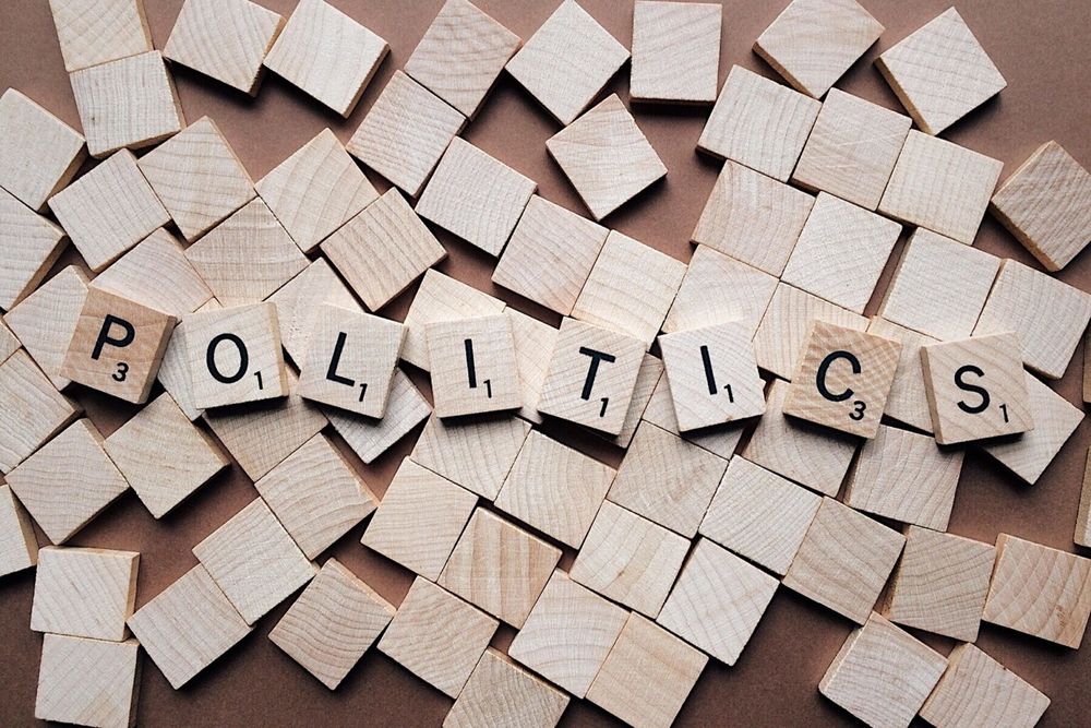The word politics is written with several wood blocks