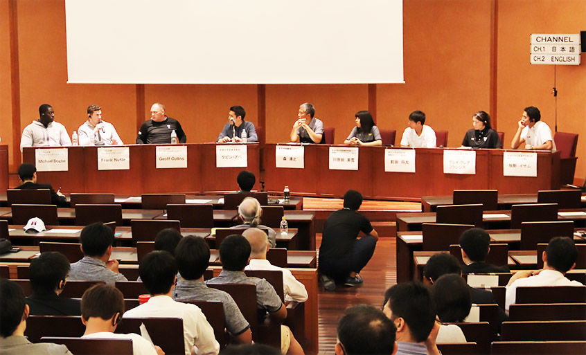 Panelists and audience at the symposium