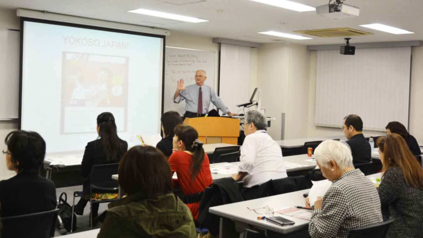 Bruce Stronach giving a lecture in front of the audience.