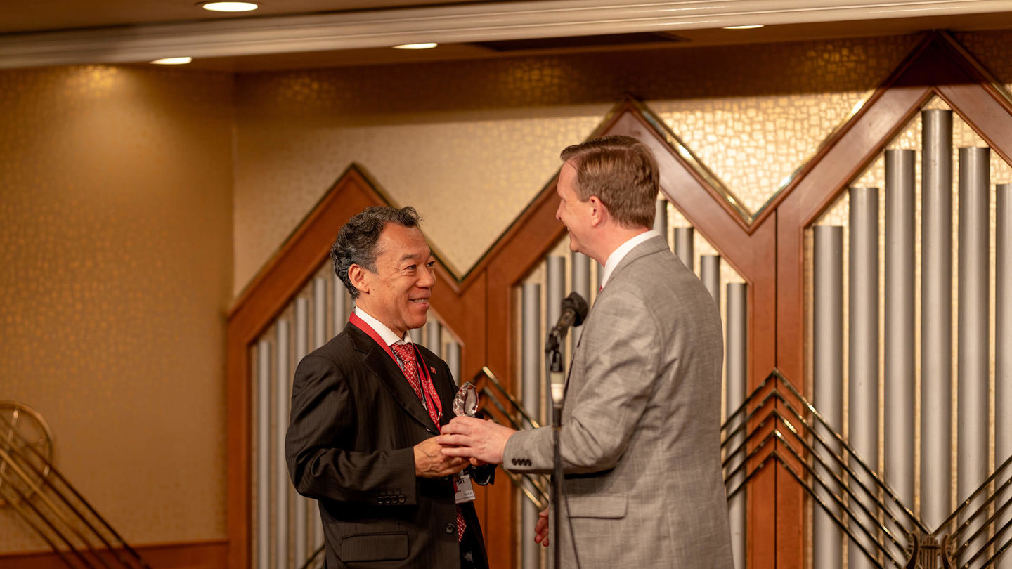 Dean Wilson presents the Distinguished Alumni Award to Toshiaki Yokozawa, one of awardees.